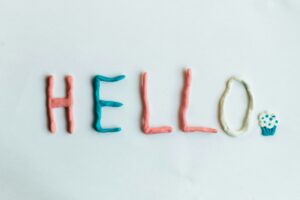 “HELLO spelled with colorful clay letters and a cupcake icon on a white background, used as a welcome image for M.I.N.D. Health and Wellness psychiatry near Hagerstown, MD.