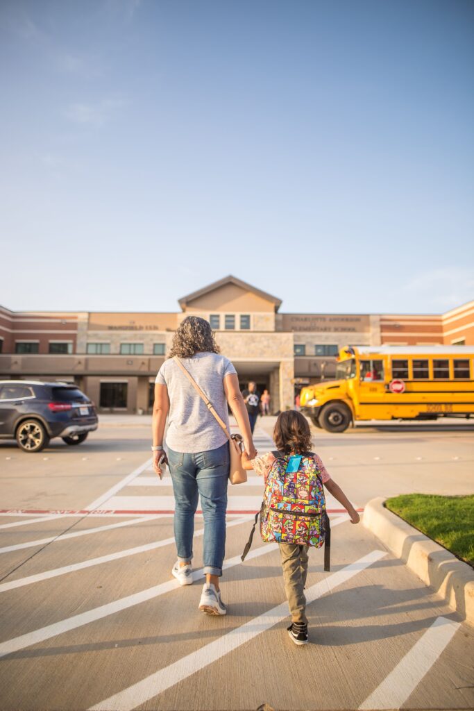 Parent walking child into school in Maryland, representing back-to-school mental health support for children and teens near Hagerstown.