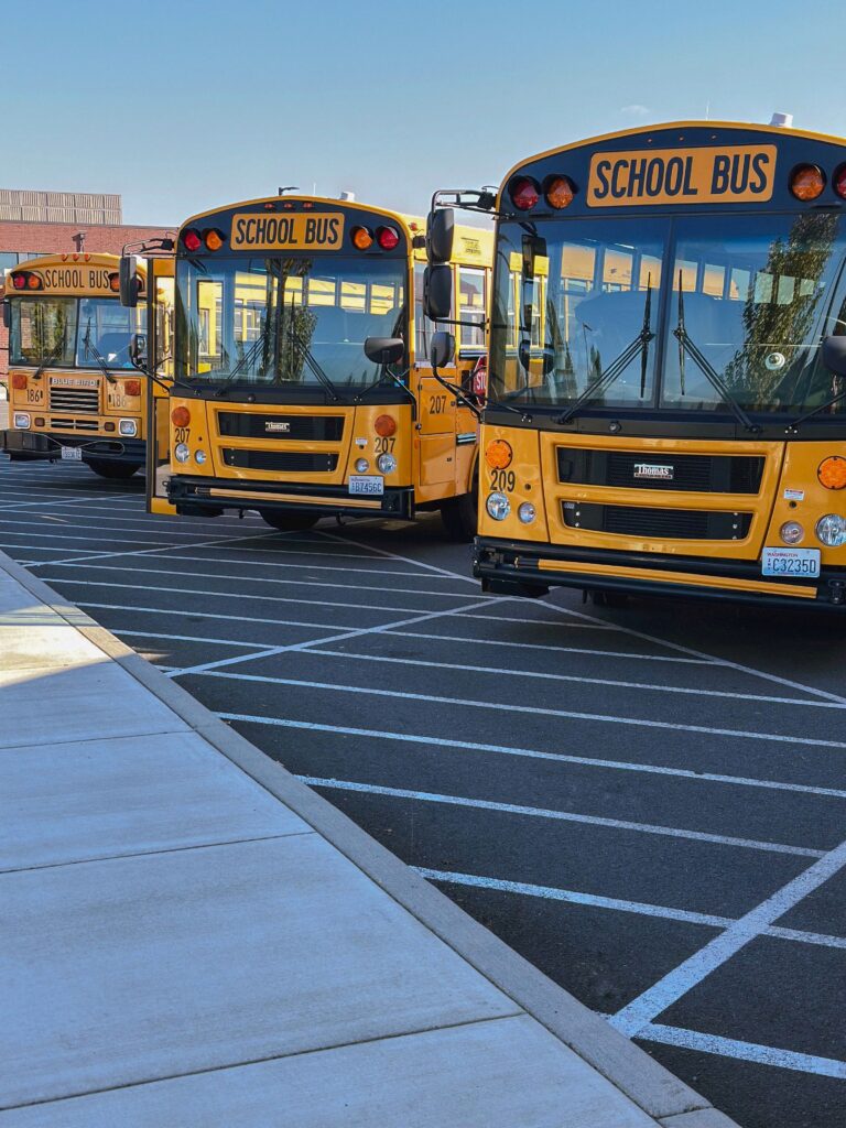 School buses parked outside a Maryland elementary school during back-to-school season, representing school readiness and student mental health.